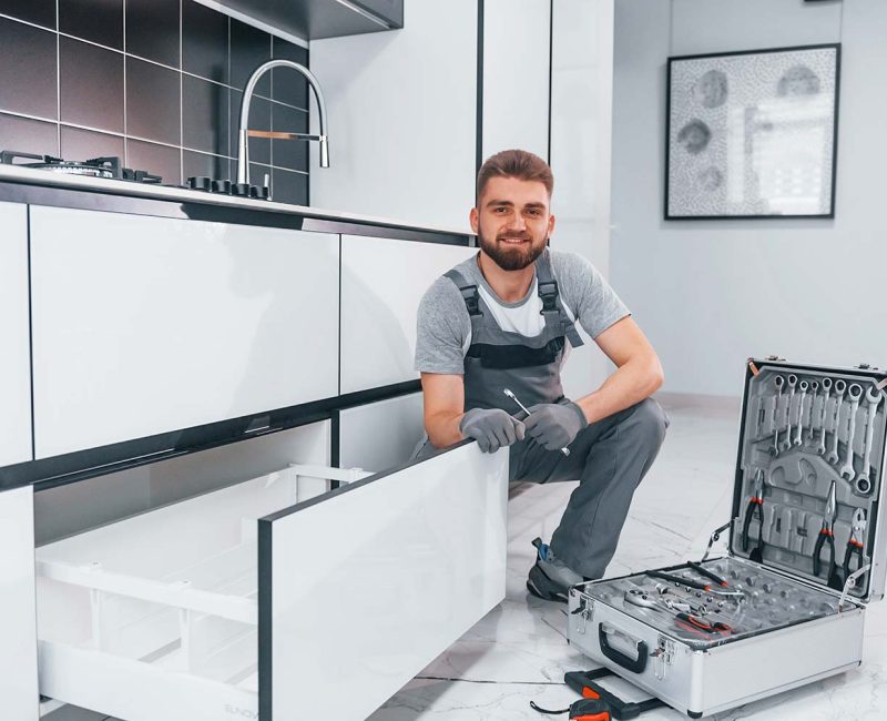 young-professional-plumber-in-grey-uniform-using-e-resize.jpg